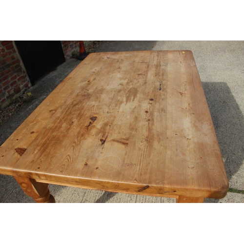 581 - A scrubbed pine kitchen table, fitted one drawer, on turned supports, 54