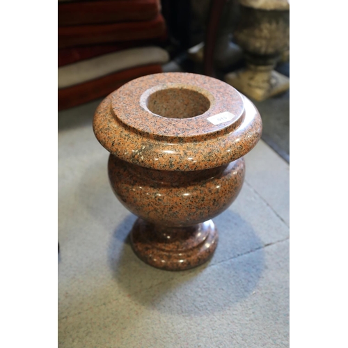 613 - A turned pink granite urn, 12