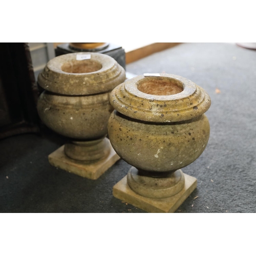 616 - A pair of marble urns, on square bases, 12