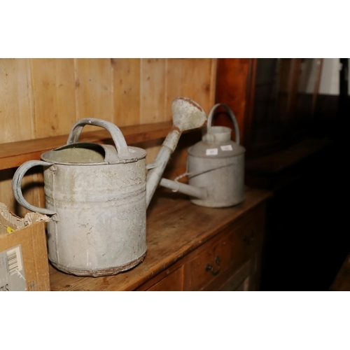 625 - A quantity of watering cans, a large number of nails and a square top table