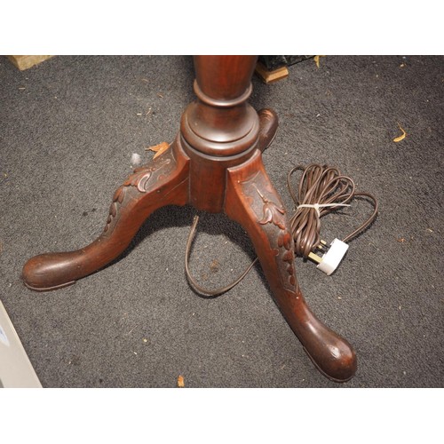 202 - A mahogany standard lamp, on turned column and carved tripod supports, 59 1/2