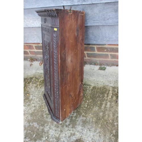 435 - A late 19th century carved mahogany corner hanging cupboard enclosed panel door, 22 1/2