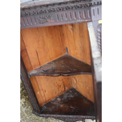 435 - A late 19th century carved mahogany corner hanging cupboard enclosed panel door, 22 1/2