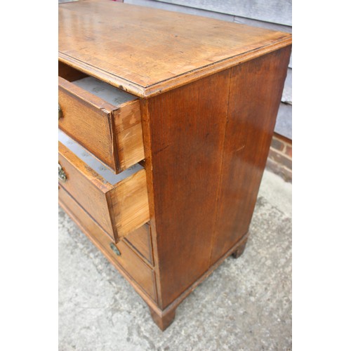 439 - A late 19th century oak and mahogany banded chest of two short and three long graduated drawers with... 