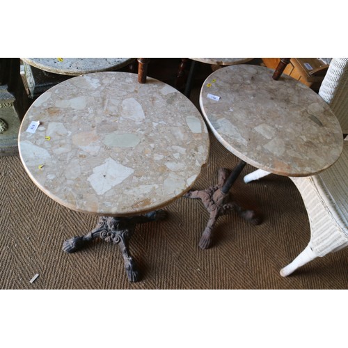 618 - A pair of circular marble topped bistro tables, on cast iron support, 19