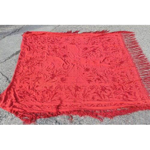 170 - An early 20th century red silk shawl with embroidery and tassel decoration, 64