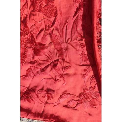 170 - An early 20th century red silk shawl with embroidery and tassel decoration, 64