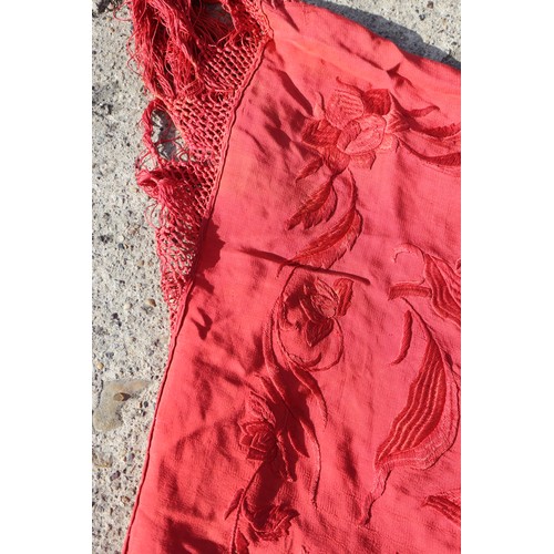 170 - An early 20th century red silk shawl with embroidery and tassel decoration, 64