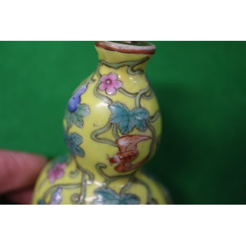 76 - A Chinese double gourd snuff bottle, decorated bats, fruits and flowers, on a yellow ground with sea... 