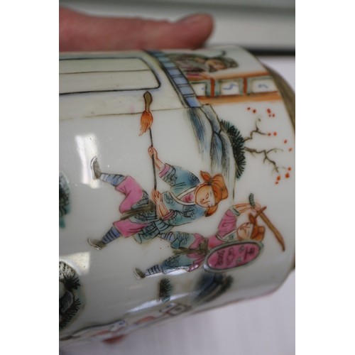 74 - A Chinese famille rose cylindrical box and cover, decorated figures in a landscape with seal mark to... 