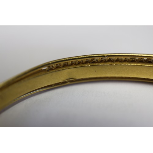 257 - A Victorian gilded 15ct gold hinged bangle, set three sapphires and eight diamonds