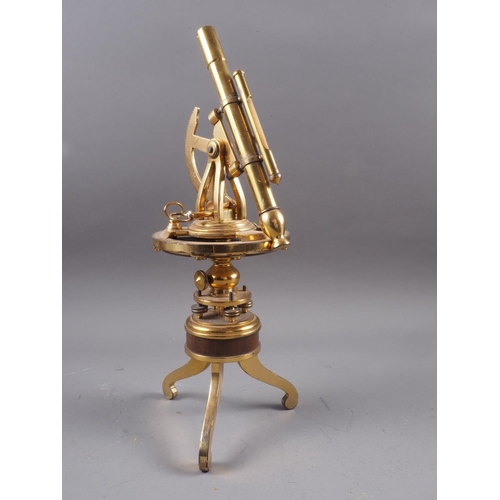 124 - A reproduction Burke & Jones brass theodolite, on tripod supports, 12 1/4