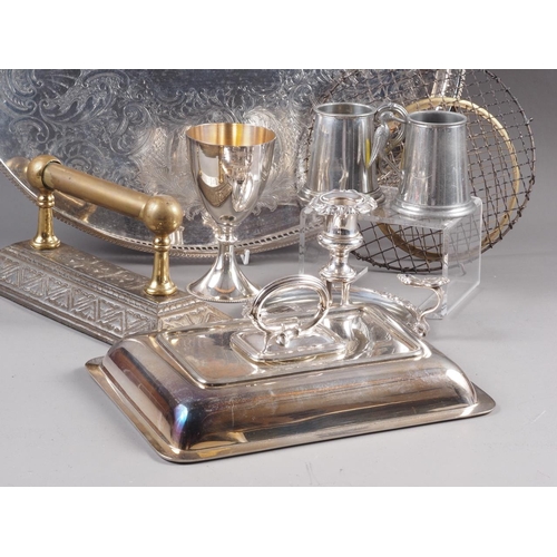 251 - A silver plated chamberstick, an entree dish cover, a plated goblet, an oval tray, 18