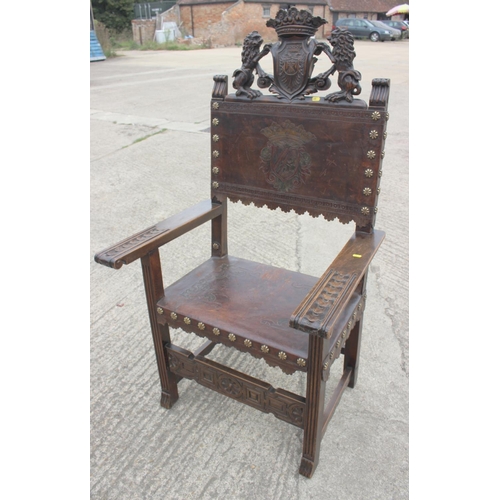 422 - A Renaissance Revival carved walnut armchair with lion and coat of arms top rail, and leather seat a... 