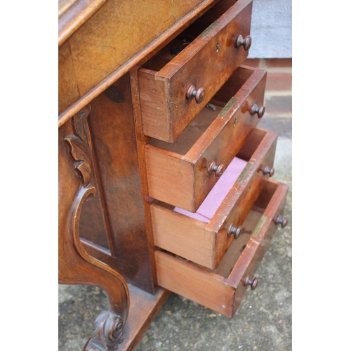 452 - A Victorian figured walnut Davenport with stationery compartment over lift-up writing slope and four... 