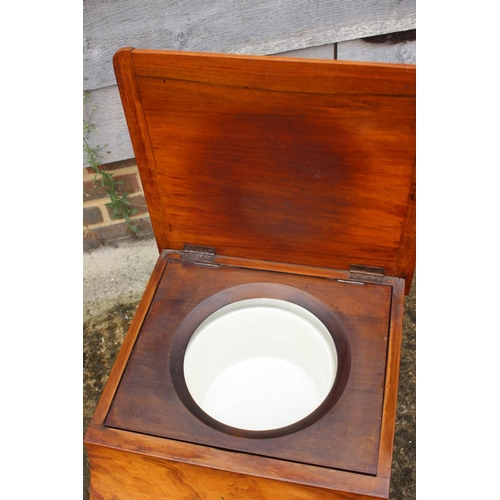 454 - A 19th century figured mahogany commode stool with liner, on turned supports, 16