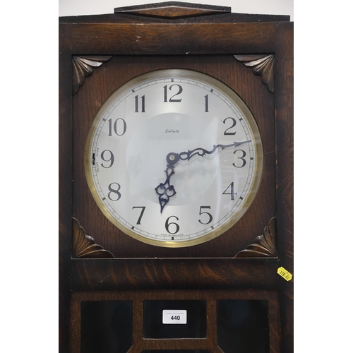 479 - A 1930s oak long case clock by Enfield with chiming movement, silvered dial and Roman numerals, 77