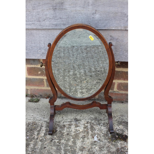 487 - A mahogany swing frame toilet mirror, on skeleton stand, 15