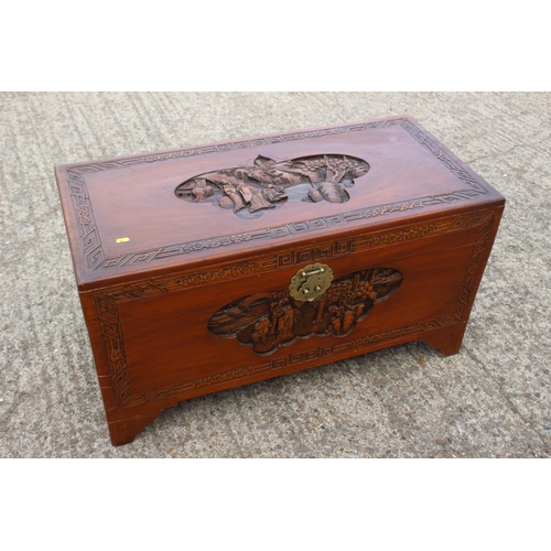 500 - A Chinese carved camphor wood chest, on bracket feet, 37