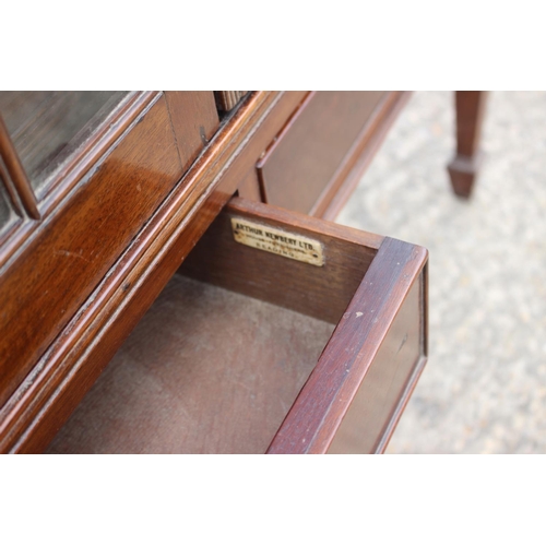 581 - A mahogany side cabinet enclosed two lattice glazed doors over two drawers, on square taper supports... 