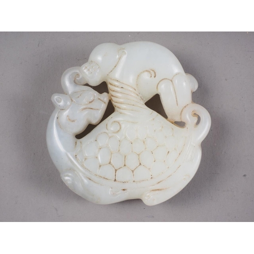 101 - A Chinese pale jade pendant with carved mythical beast decoration, 2