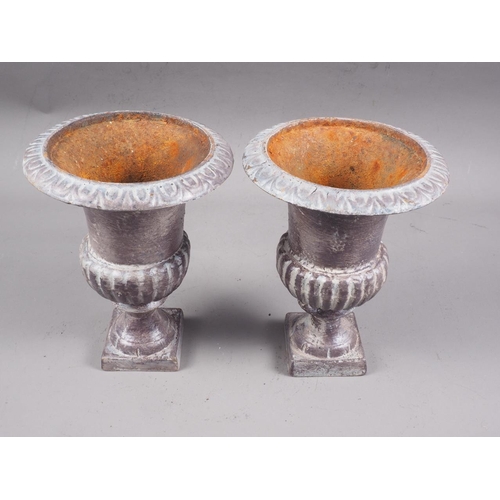 148 - A pair of early 20th century cast iron campana urns, 8