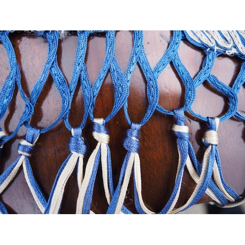 188 - An early 20th century blue silk shawl with ribbon and tassel decoration, 44