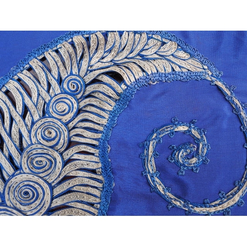 188 - An early 20th century blue silk shawl with ribbon and tassel decoration, 44