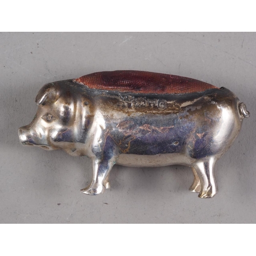 258 - An Edwardian silver pincushion, in the form of a pig, a silver bookmark with bookworm terminal, a ch... 