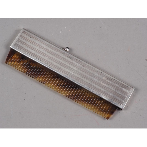 267 - A silver engine turned cased retractable comb