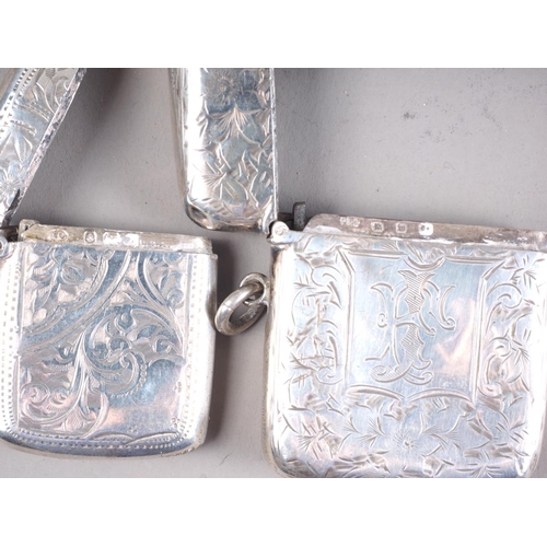 275 - A silver snuff box with engraved decoration, two silver vesta cases and a silver cased dip pen and p... 