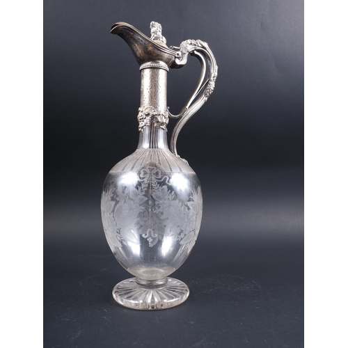 276 - A late 19th century silver mounted claret jug with shell engraved decoration, 11 1/2