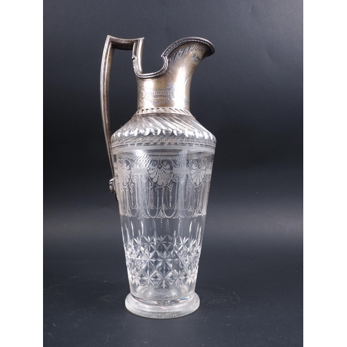 276 - A late 19th century silver mounted claret jug with shell engraved decoration, 11 1/2