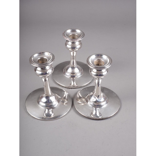 277 - Three silver squat candlesticks, on plain circular bases, 5