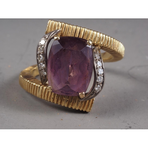 300 - An 18ct gold ring, set amethyst and white sapphire