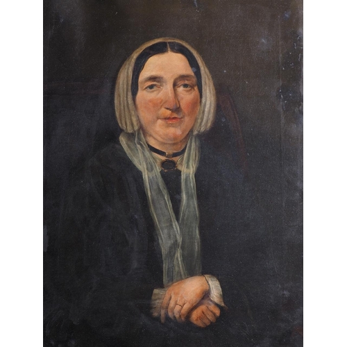 414 - A mid 19th century oil on canvas portrait of a woman with clasped hands, 20 1/2