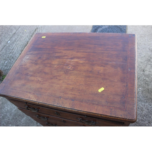 423 - A bachelor's Georgian walnut and banded box and ebony strung chest of four long graduated drawers wi... 