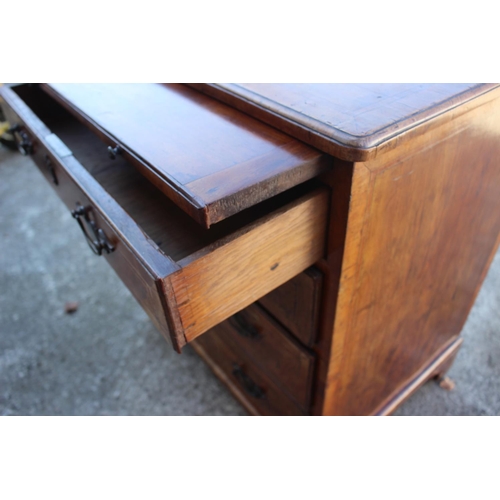 423 - A bachelor's Georgian walnut and banded box and ebony strung chest of four long graduated drawers wi... 