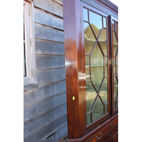 425 - A George III mahogany corner cabinet, the upper section enclosed astragal glazed doors over one long... 