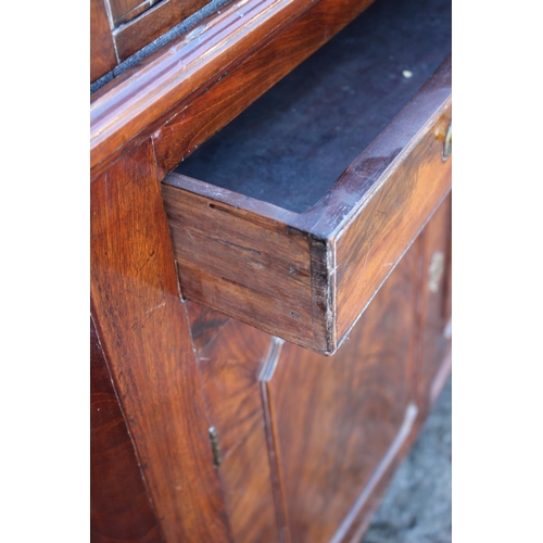 425 - A George III mahogany corner cabinet, the upper section enclosed astragal glazed doors over one long... 