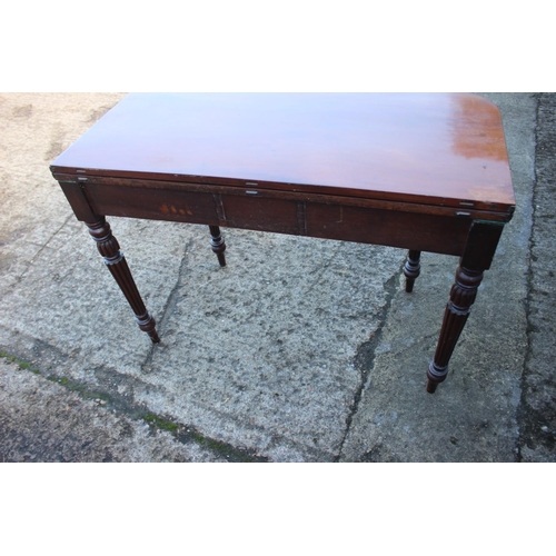 427 - A 19th century mahogany fold-over top tea table, fitted one frieze drawer, on turned and fluted supp... 