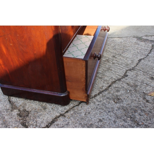 429 - A Victorian mahogany chest of two short and two long graduated drawers with knob handles, on block b... 