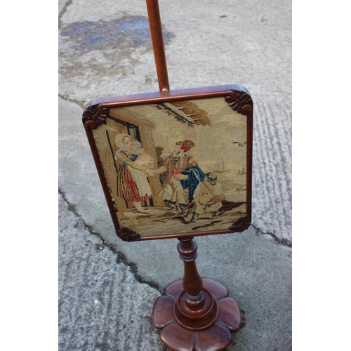 430 - A pair of early 19th century mahogany framed pole screens with needlepoint figured panels, on hexafo... 