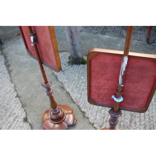 430 - A pair of early 19th century mahogany framed pole screens with needlepoint figured panels, on hexafo... 