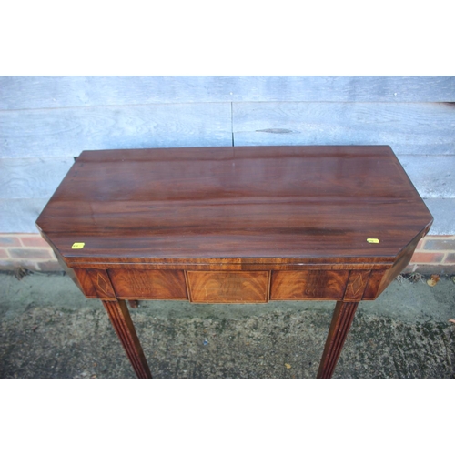 433 - A 19th century mahogany, ebony strung and satinwood banded fold-over top tea table, on reeded taperi... 