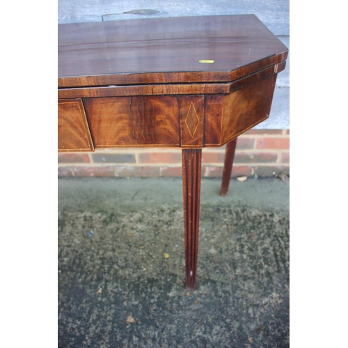 433 - A 19th century mahogany, ebony strung and satinwood banded fold-over top tea table, on reeded taperi... 