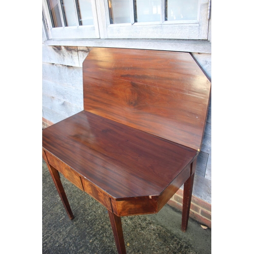 433 - A 19th century mahogany, ebony strung and satinwood banded fold-over top tea table, on reeded taperi... 