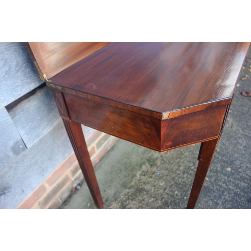 433 - A 19th century mahogany, ebony strung and satinwood banded fold-over top tea table, on reeded taperi... 