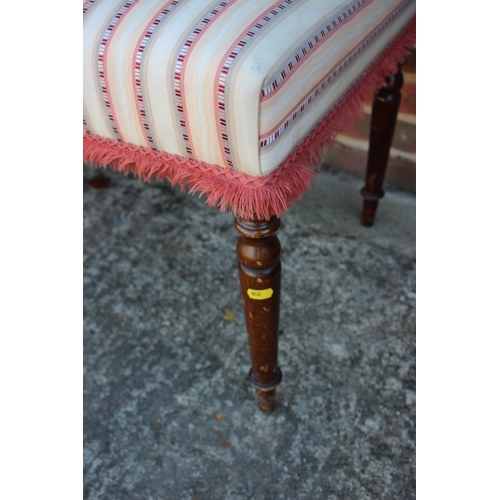 439 - A mahogany stool, upholstered in a striped fabric, on turned supports, 48