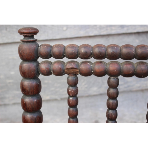 465 - A pair of 19th century rosewood bobbin turned low seat nursing chairs, on turned supports